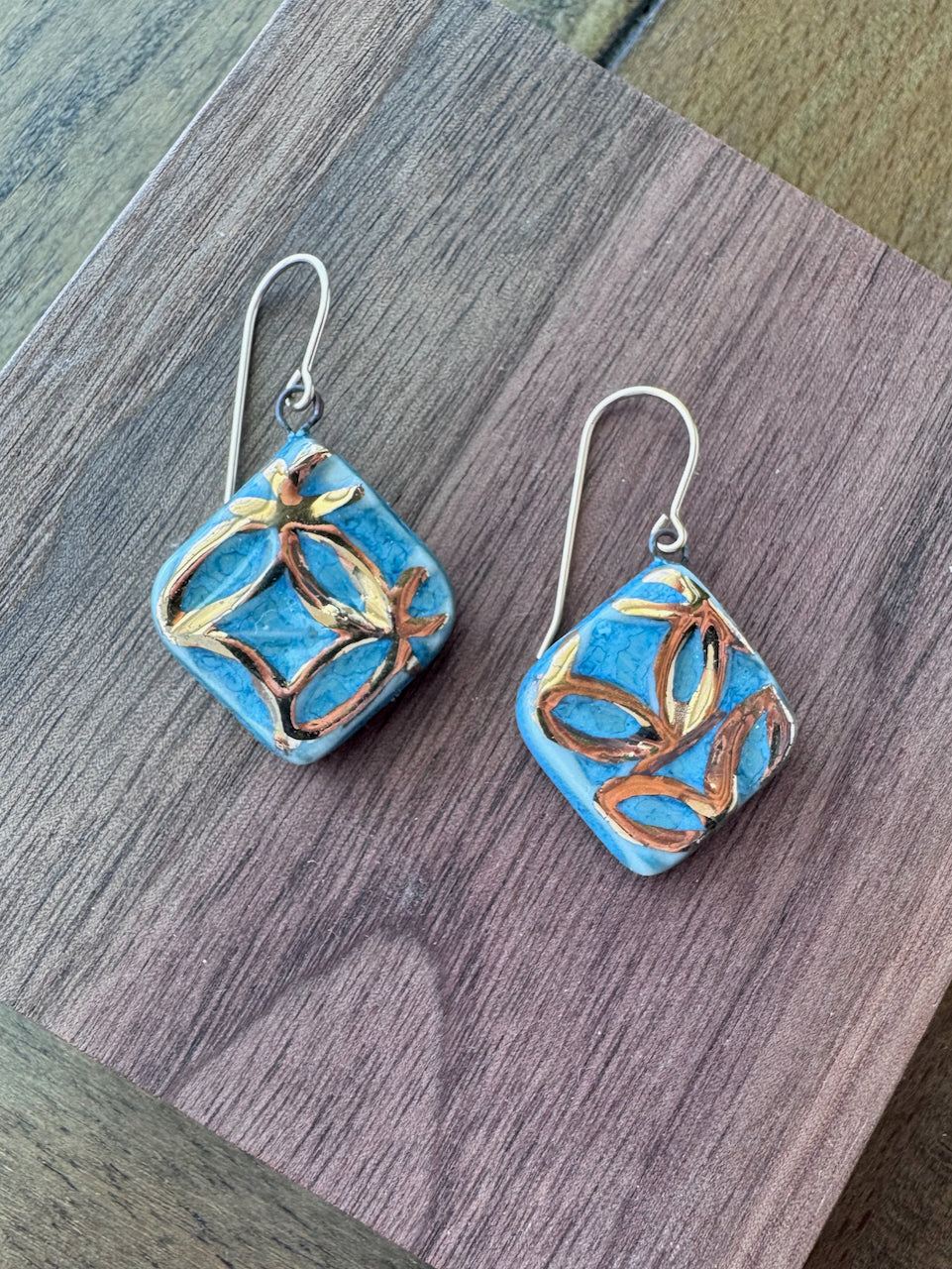 Blue handcrafted porcelain Aurelia earrings with raised geometric details and hand-applied 22k gold.