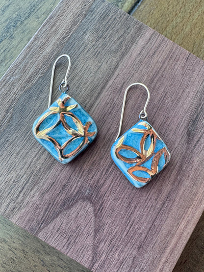 Blue handcrafted porcelain Aurelia earrings with raised geometric details and hand-applied 22k gold.