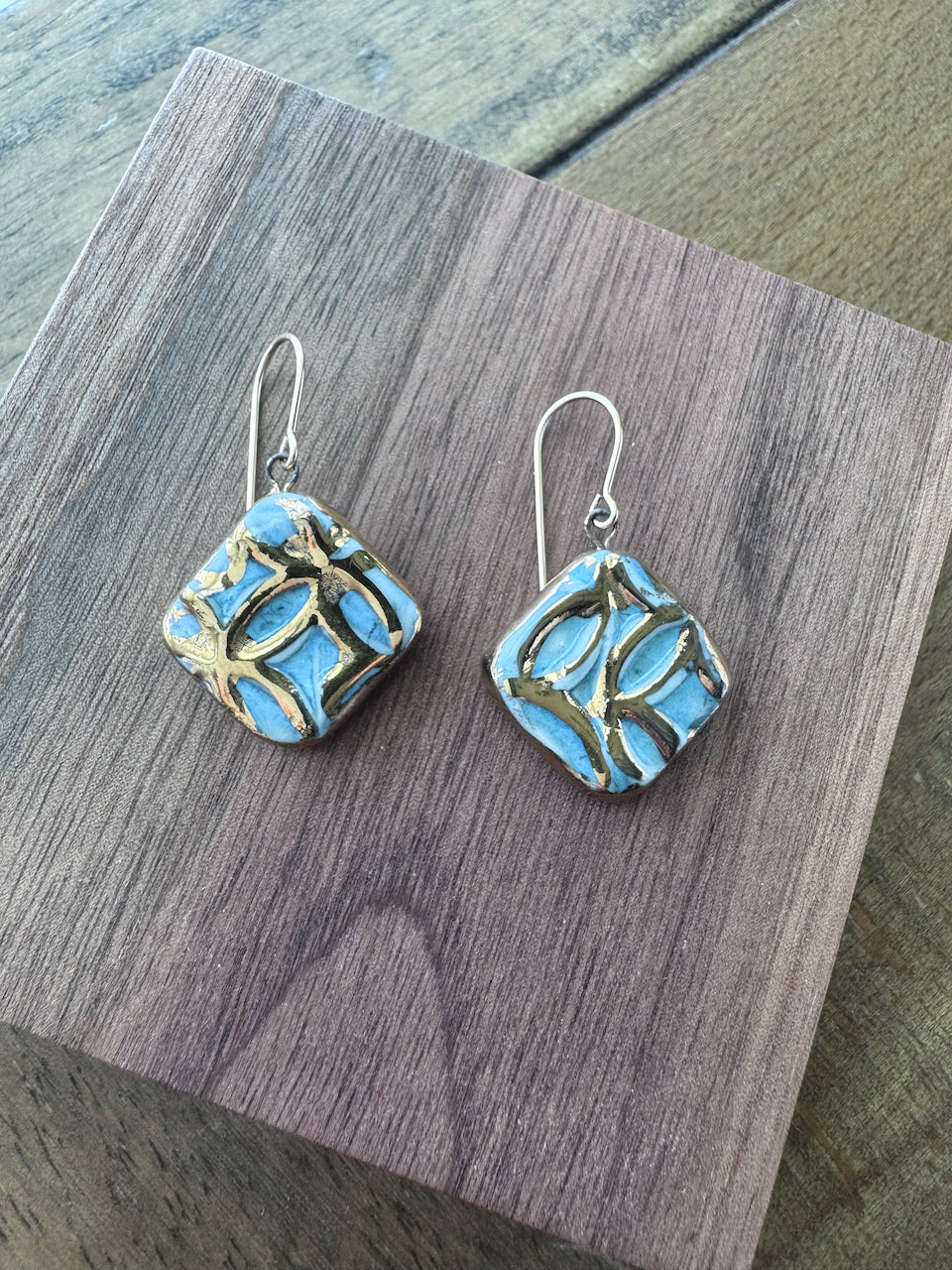 Blue handcrafted porcelain Aurelia earrings with raised geometric details and hand-applied 22k gold.