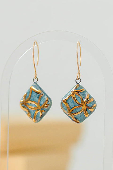 Blue handcrafted porcelain Aurelia earrings with raised geometric details and hand-applied 22k gold.