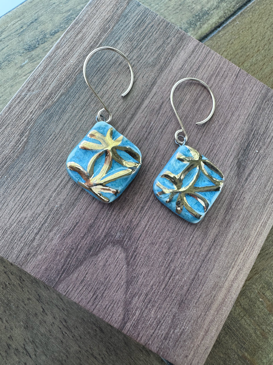 Blue handcrafted porcelain Aurelia earrings with raised geometric details and hand-applied 22k gold.