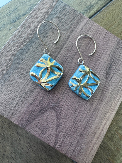 Blue handcrafted porcelain Aurelia earrings with raised geometric details and hand-applied 22k gold.