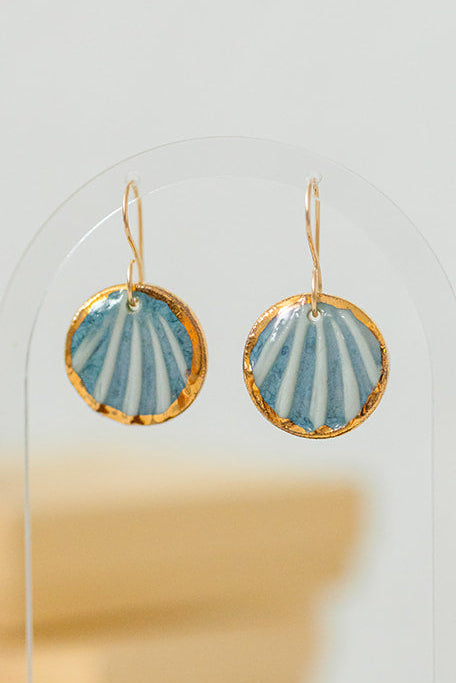 Handcrafted blue porcelain Maris earrings with shell-inspired texture and hand-applied 22k gold accents.