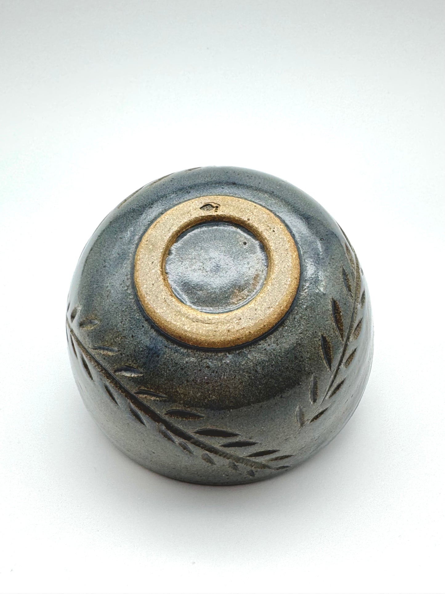 Small ceramic bowl with a textured surface on a white background