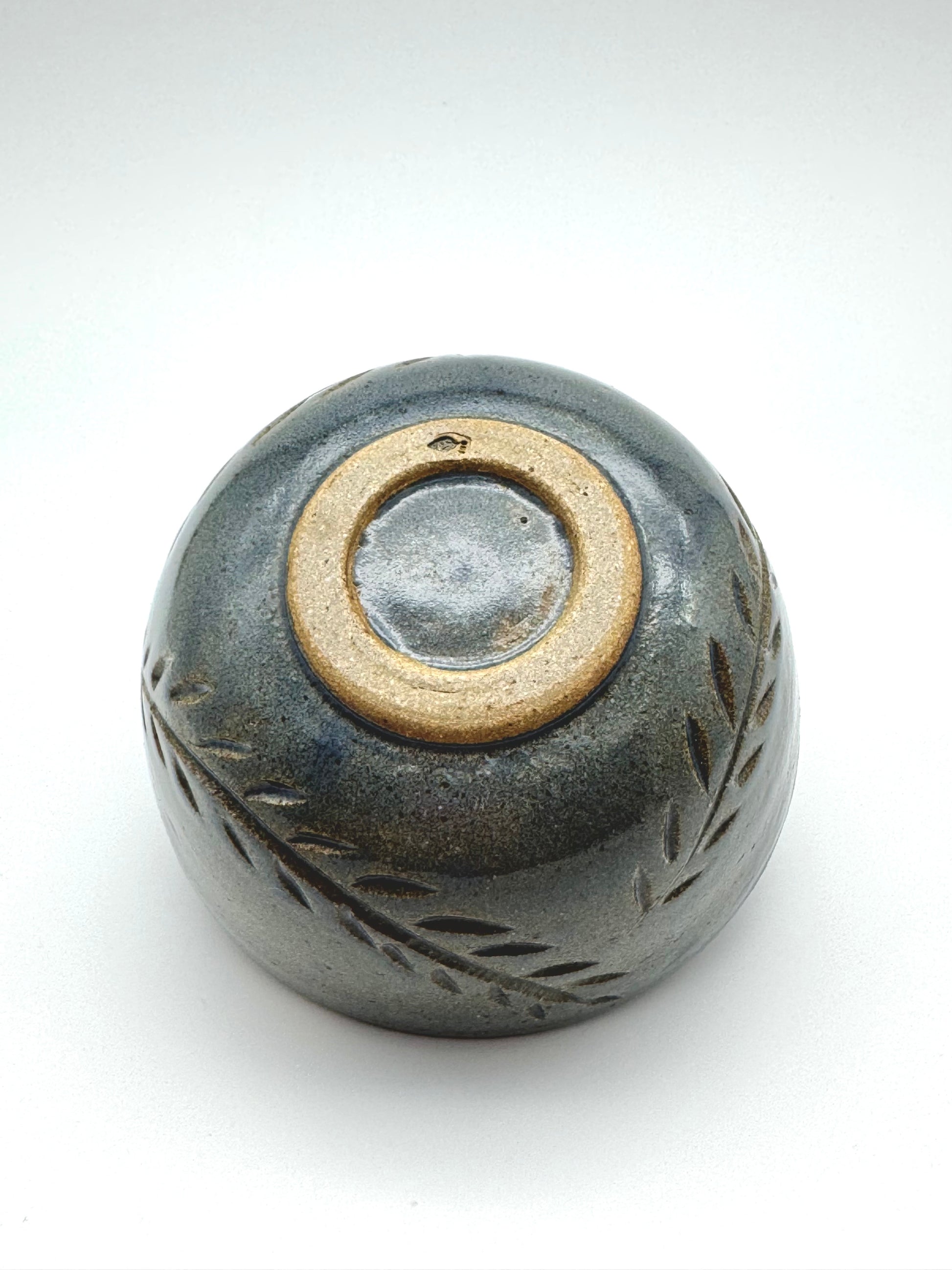Small ceramic bowl with a textured surface on a white background