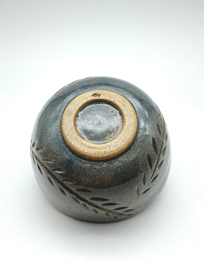Small ceramic bowl with a textured surface on a white background