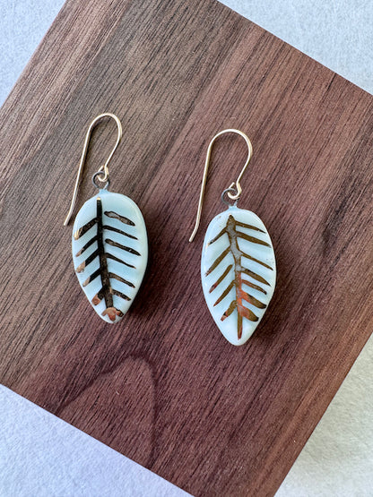 Celadon porcelain leaf earrings featuring hand-applied 22k gold botanical details and gold-filled ear wires.