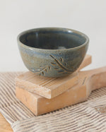 Load image into Gallery viewer, Ceramic bowl with leaf design on a wooden block
