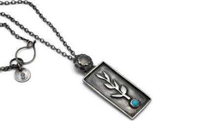 Handcrafted sterling silver necklace with a botanical branch design and Sleeping Beauty turquoise stone.